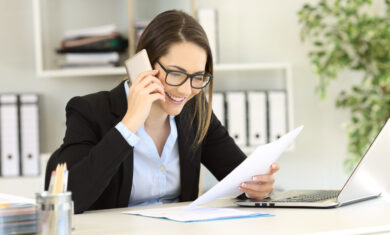 Happy customer calling support service about a paper document at office