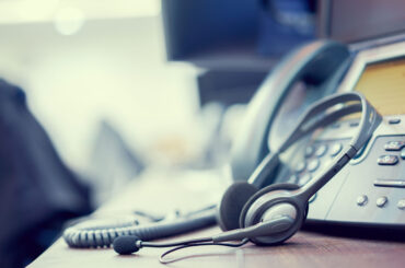 close up soft focus on headset with telephone devices at office