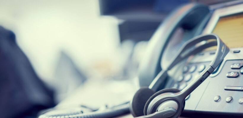 close up soft focus on headset with telephone devices at office